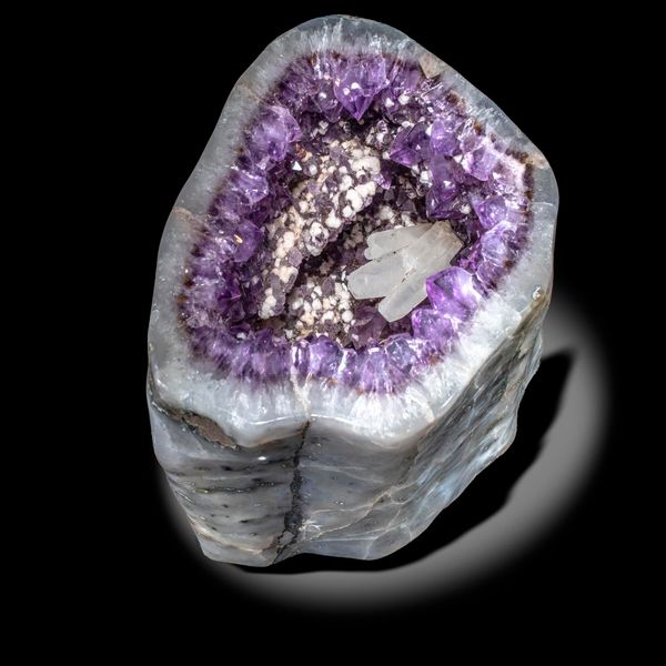 An amethyst geode with calcite crystals Brazil 29cm by 27cm