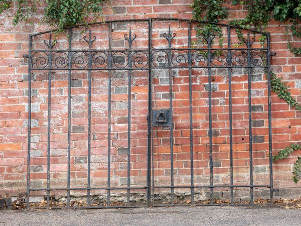 A pair of wrought iron gates late 19th century 180cm high by 224cm wide