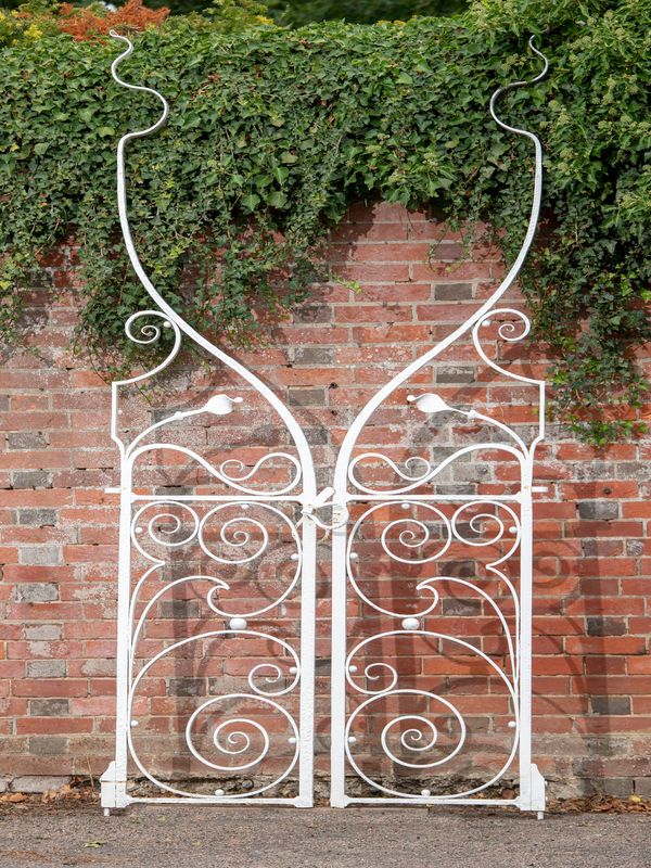 A pair of unusual wrought iron gates circa 1900 294cm high by 112cm wide