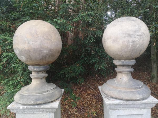 A near pair of terracotta gatepier balls 80cm high