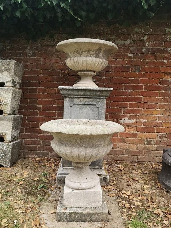 A pair of carved limestone urns mid 19th century  63cm diameter