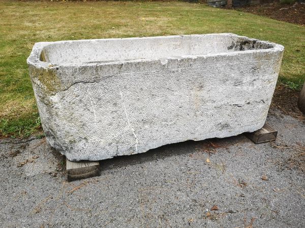 A carved blue stone trough Low Countries, 18th century 49cm high by 136cm long by 64cm deep
