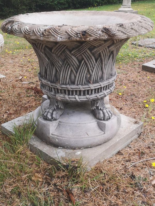 A composition stone basket on pedestal modern 64cm high by 78cm diameter