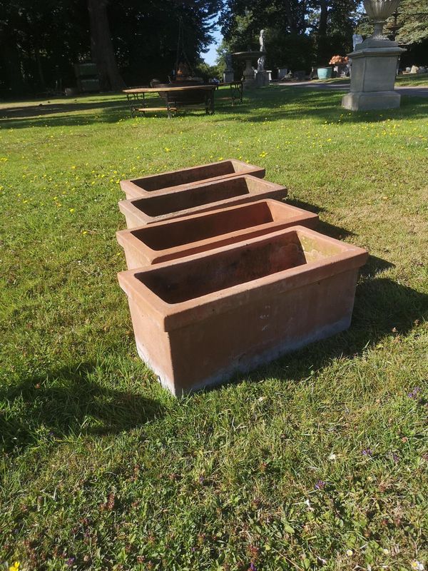 A similar set of four rectangular terracotta planters