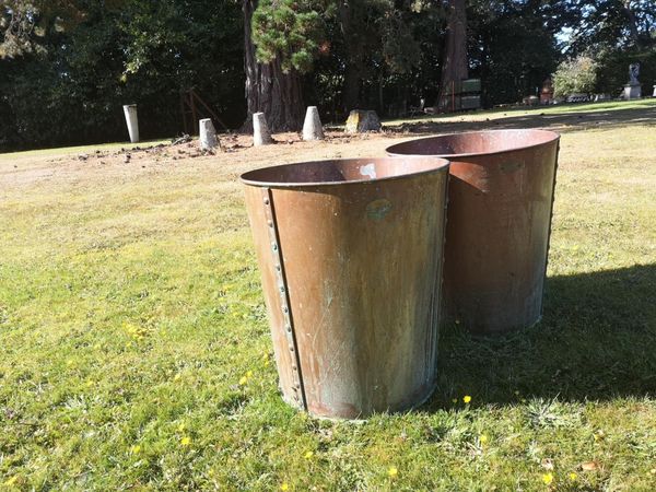 A pair of riveted copper planters last quarter 20th century  with makers plaque 57cm high by 52cm diameter