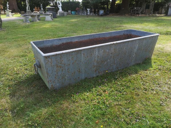 A cast iron trough 19th century 38cm high by 156cm long