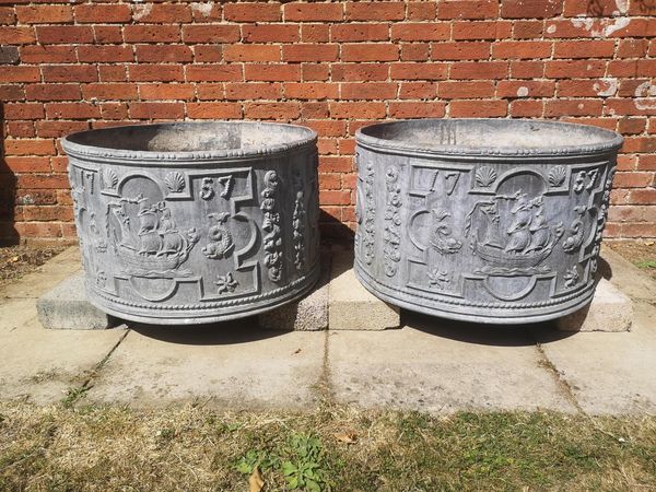 A pair of cylindrical lead planters modern bearing the date 1757 47cm high by 77cm diameter