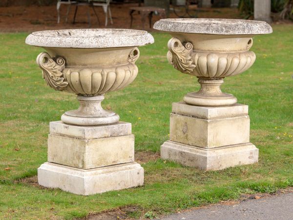 A pair of composition stone Pulham style urns on pedestals late 20th century 105cm high by 90cm diameter