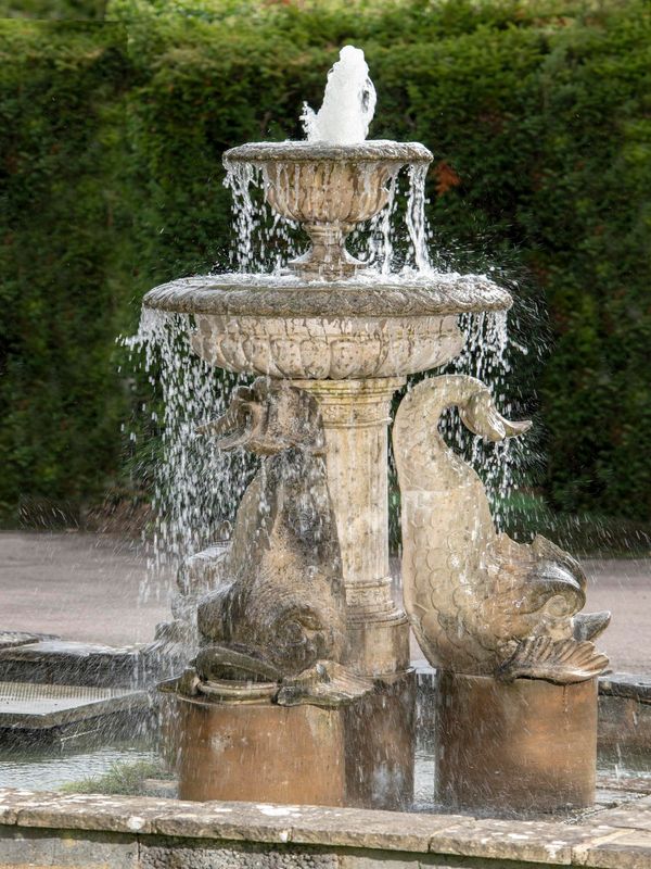 A composition stone fountain 205cm high by 125cm wide