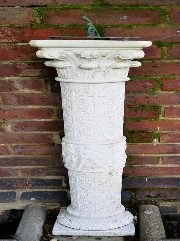 A Romanesque style composition stone sundial with bronze plate 115cm high overall