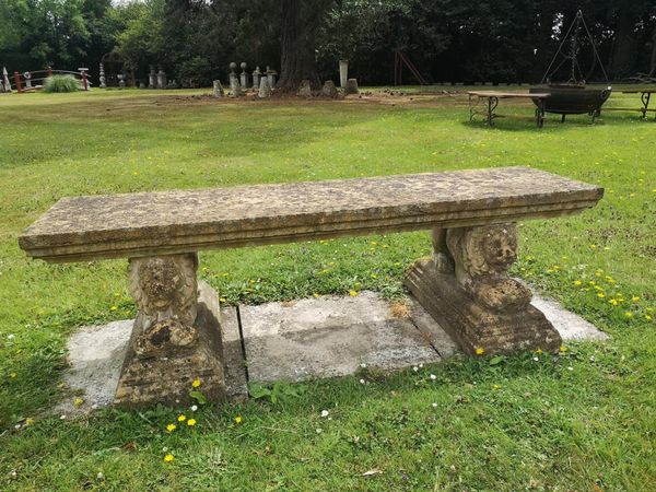 A composition stone bench on reclining lion support 2nd half 20th century  166cm wide