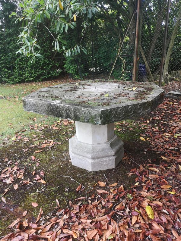 A composition stone table 124cm wide