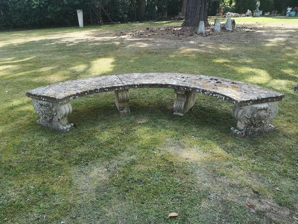 A substantial composition stone curved seat 2nd half 20th century 310cm wide