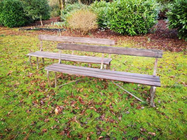 A pair of wrought iron and wooden slatted seats circa 1900 183cm long