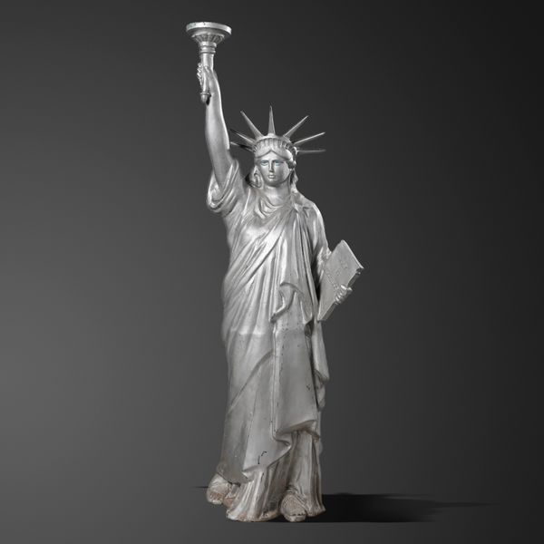 After Frédéric Auguste Bartholdi: A metal alloy figure of the statue of Liberty 20th century holding a table inscribed July 4th 1875 in roman...