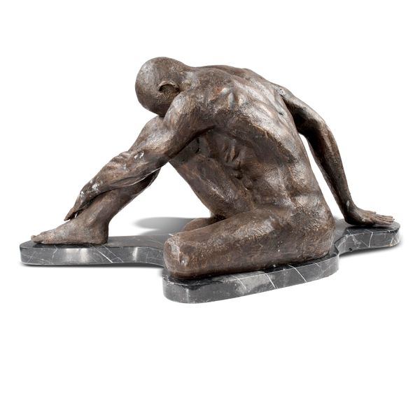 A bronze figure of a seated naked athlete modern on veined black marble base 37cm high by 80cm long