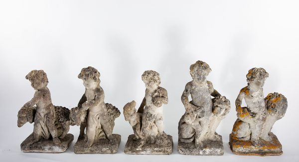 A set of five carved limestone putti