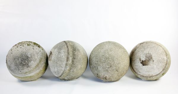 A set of four large composition stone balls