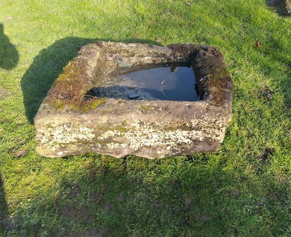 A sloping rectangular carved stone trough