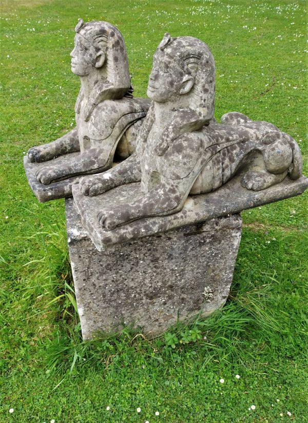 A pair of composition stone sphinxes