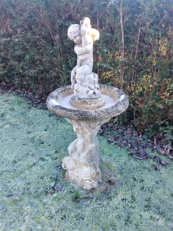 A carved Marble Fountain of Boy holding a fish