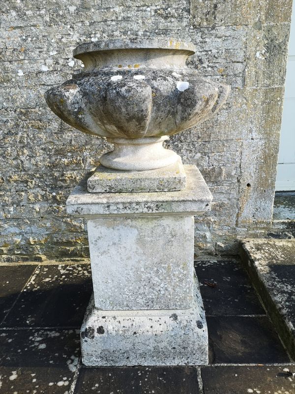 A pair of rare Austin and Seeley composition stone urns