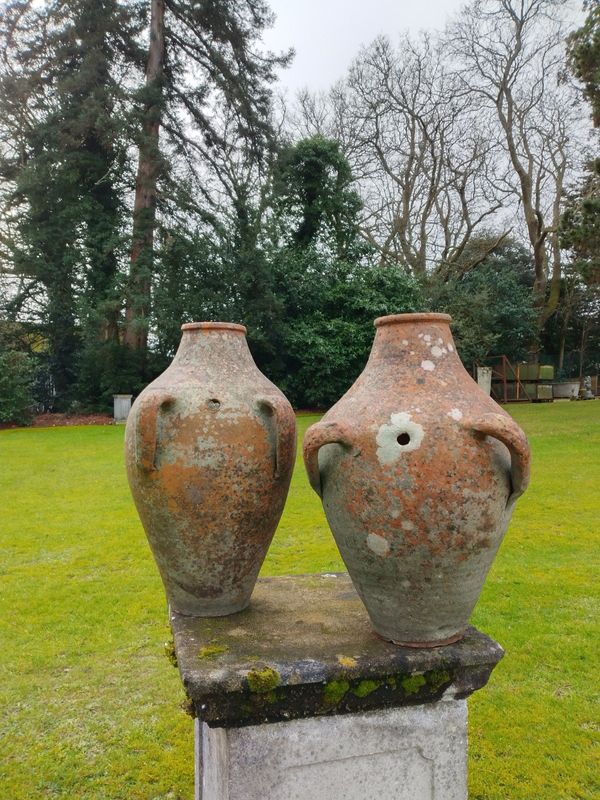 A pair of unusual offset double handled terracotta pots