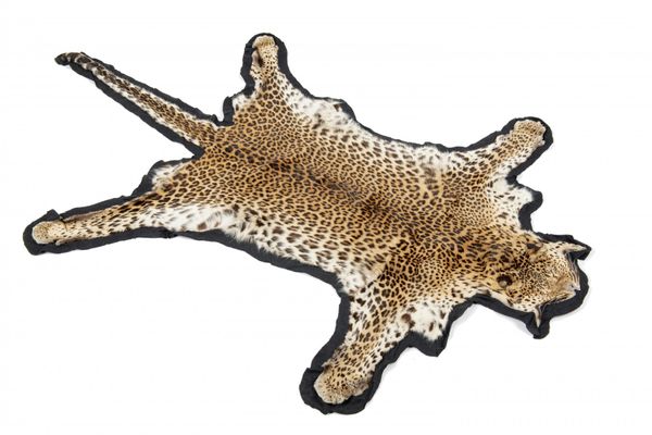 A Leopard skin felt backed rug