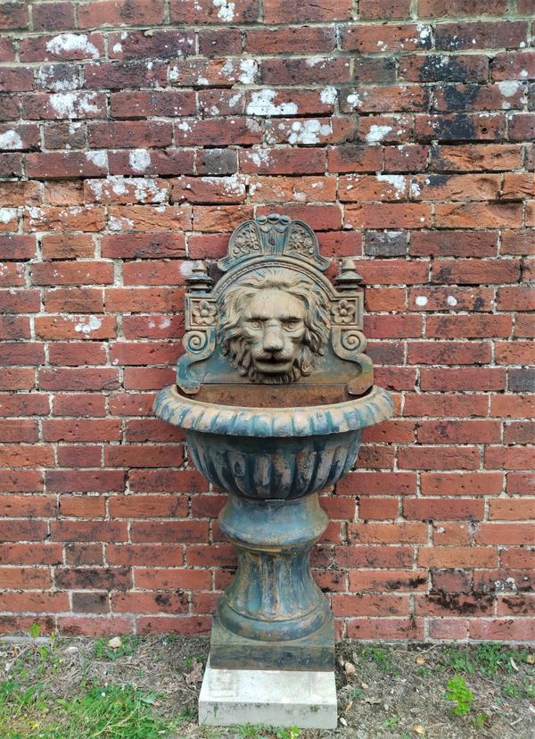 A cast iron wall fountain modern