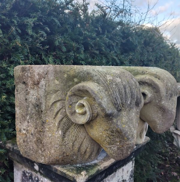 Two carved limestone rams head corbels