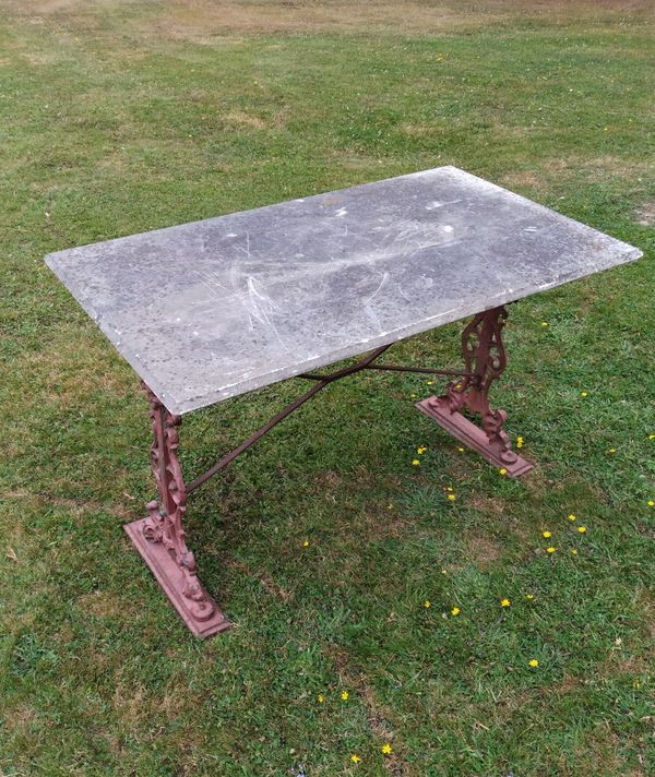 A  cast iron table with marble top