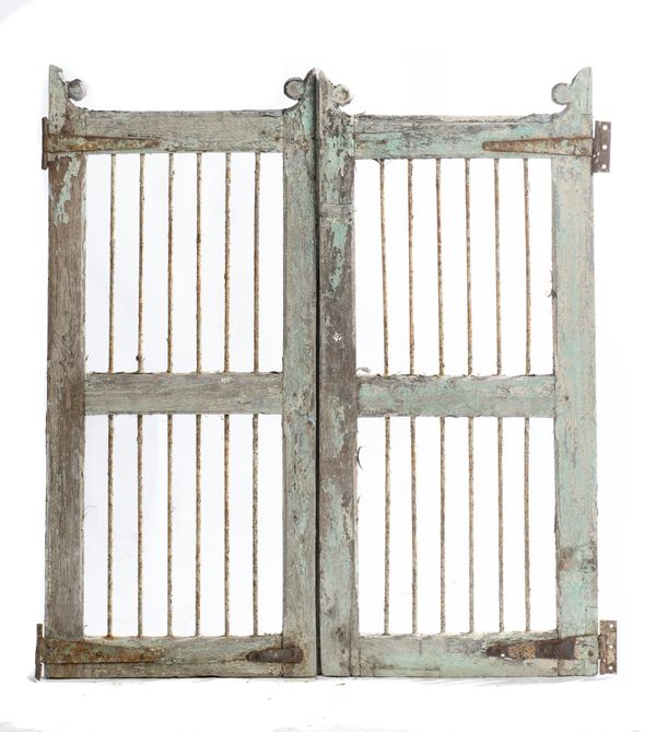 A pair of green painted wooden gates