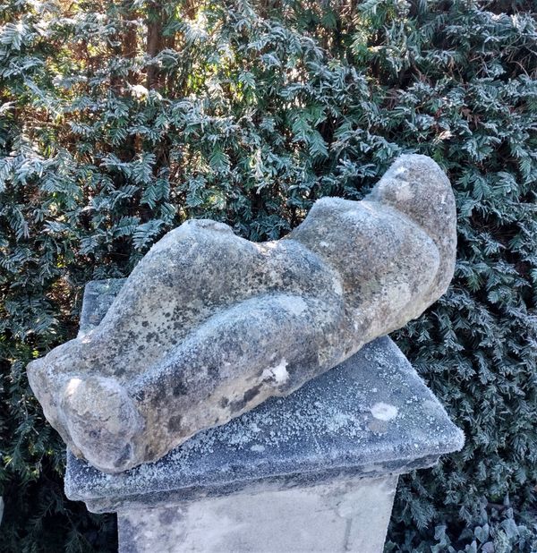 A studio carved stone reclining figure