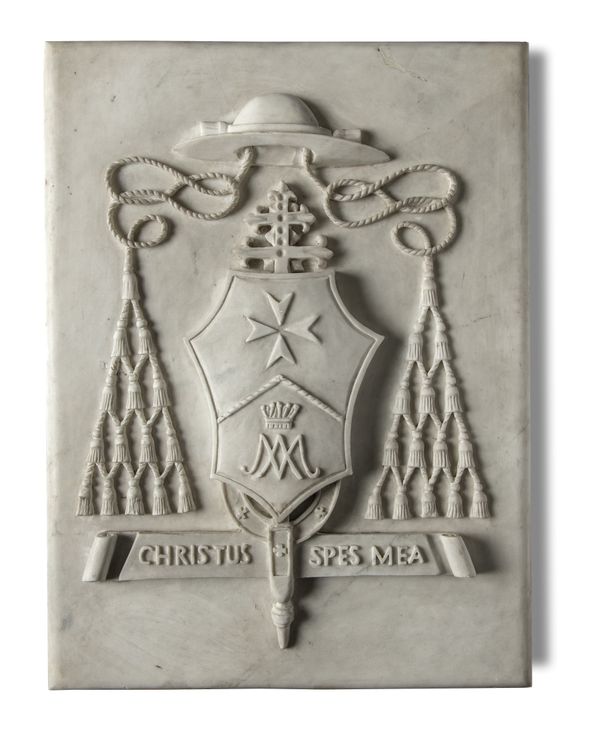 A carved white marble papal coat of arms plaque