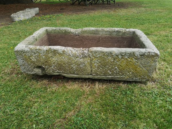 A rectangular carved stone trough