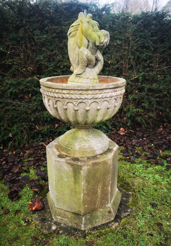 A composition stone fountain on pedestal