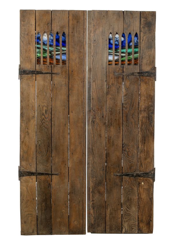 A pair of elm wood doors with inset leaded stained glass panels