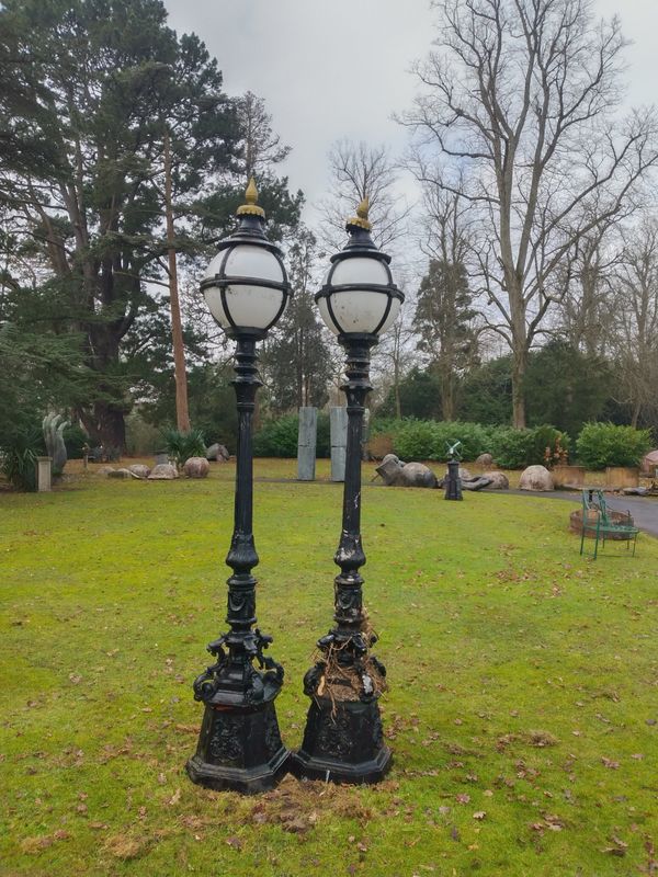 A pair of painted aluminium standing lamps