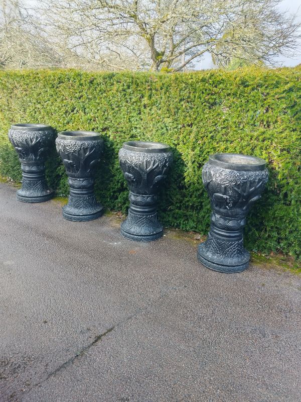 A pair of carved granite bowls on stands