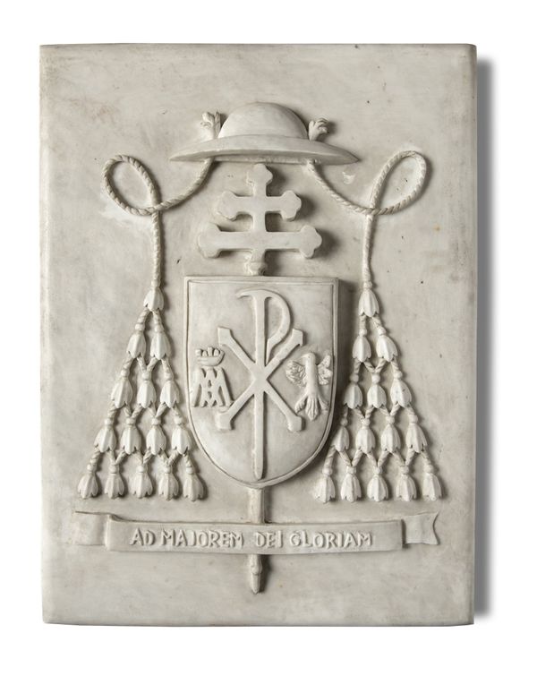 A similar carved white marble papal coat of arms plaque