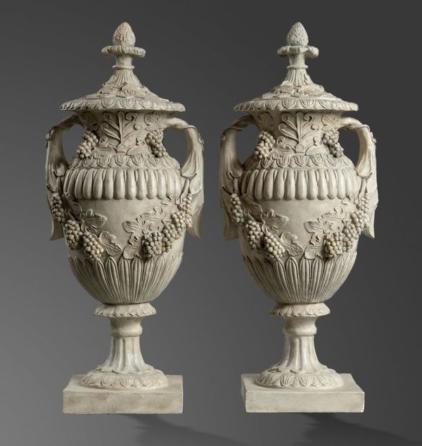 A pair of lidded plaster urns