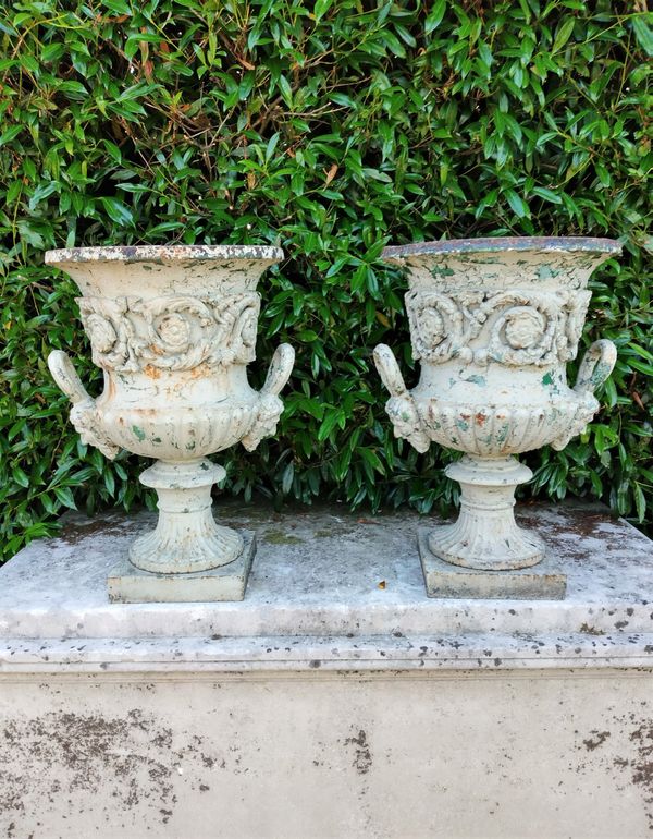 A pair of Handyside foundry cast iron urns