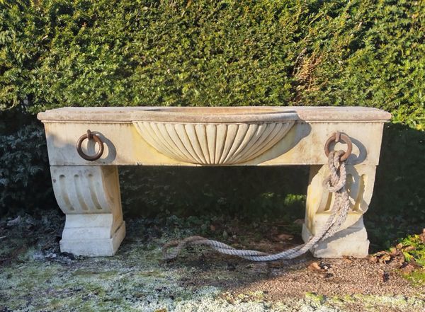 A composition stone wall trough