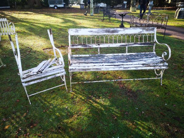 A wrought iron and wooden seat