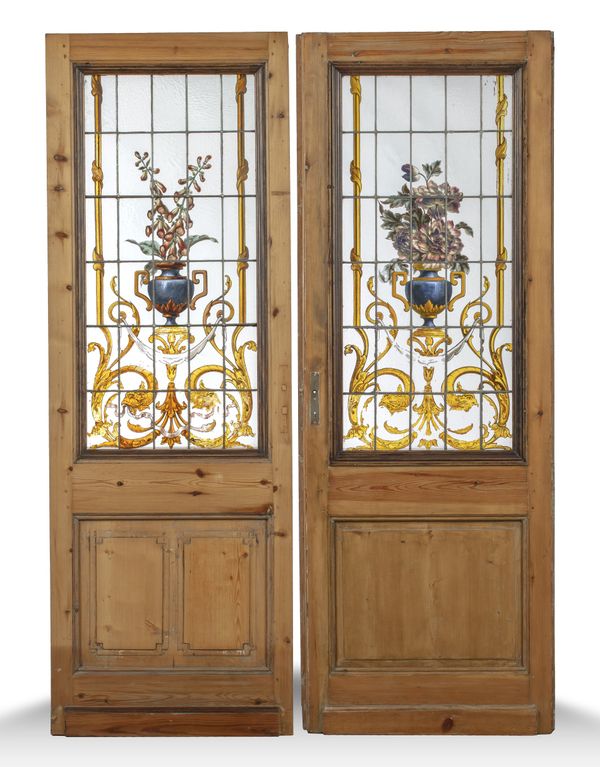 A similar pair of pine doors with stained glass panels
