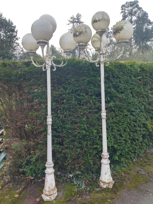 A set of four aluminium standing lamps
