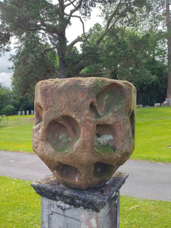 A rare  and early carved sandstone polyheaded  sundial