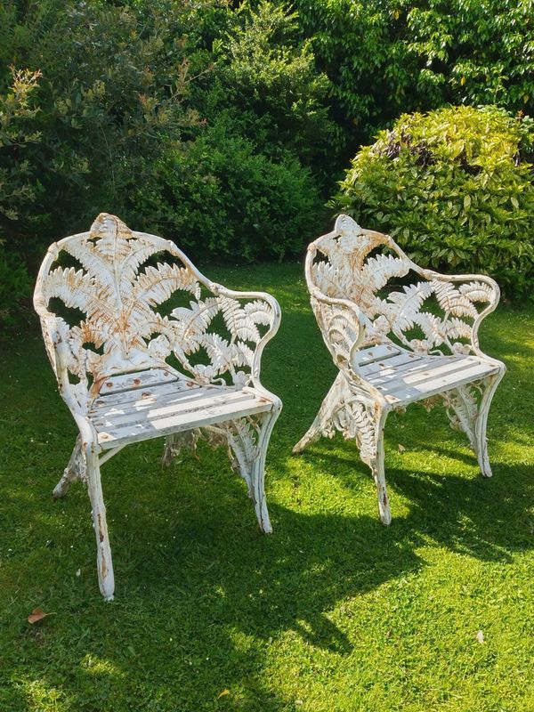 A similar pair of Coalbrookdale Fern and Blackberry pattern cast iron chairs