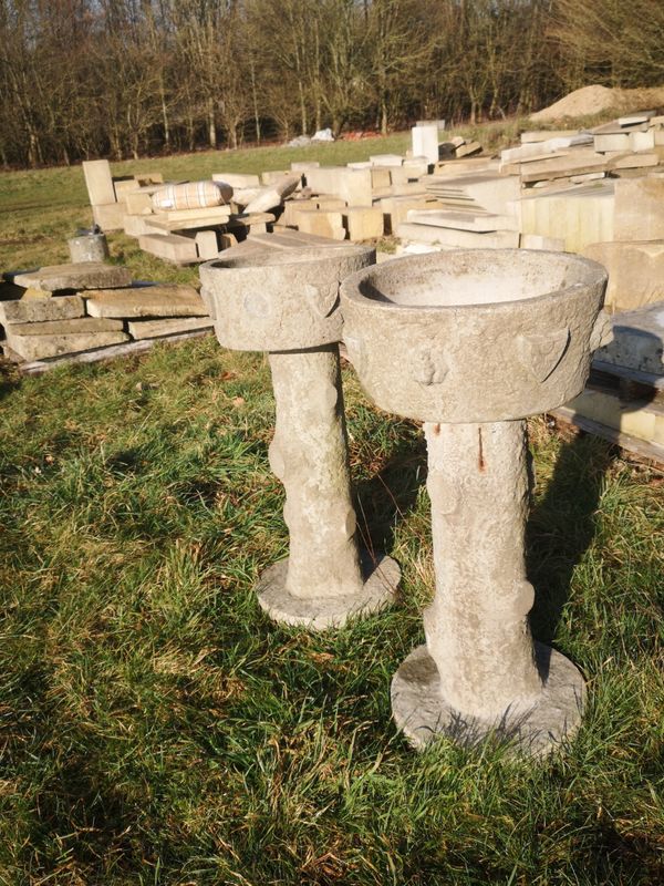 A pair of composition stone birdbaths