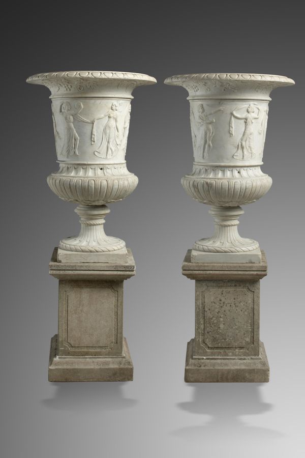 A pair of carved white marble urns